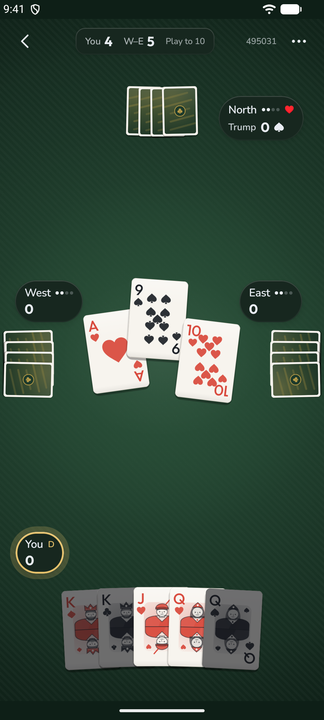 Euchre on the Velvet table with the Ink deck: a green nap under the light, three cards in the trick, court cards fanned at the bottom, North marked as trump-maker